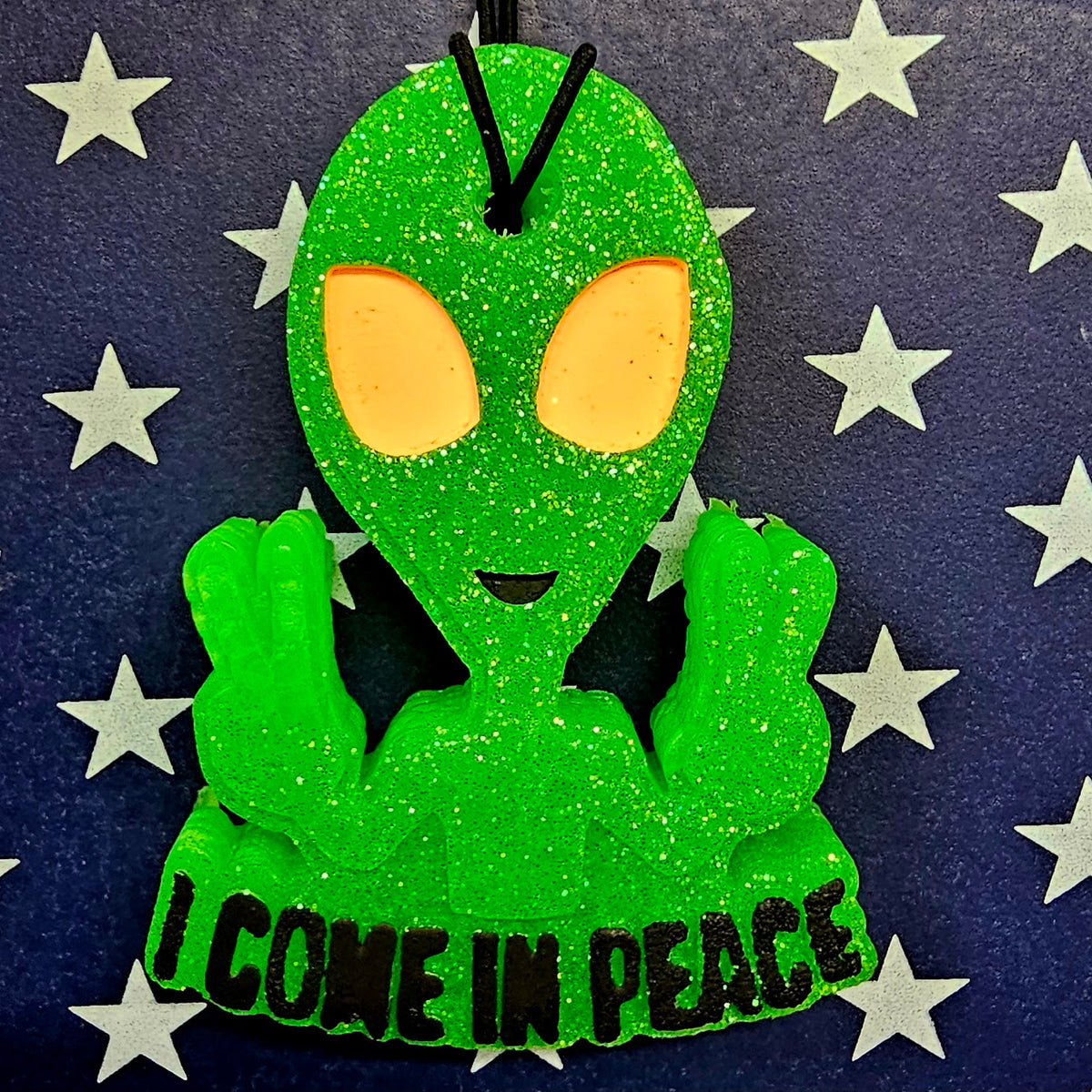 Green alien I Come in Peace freshie on star background
