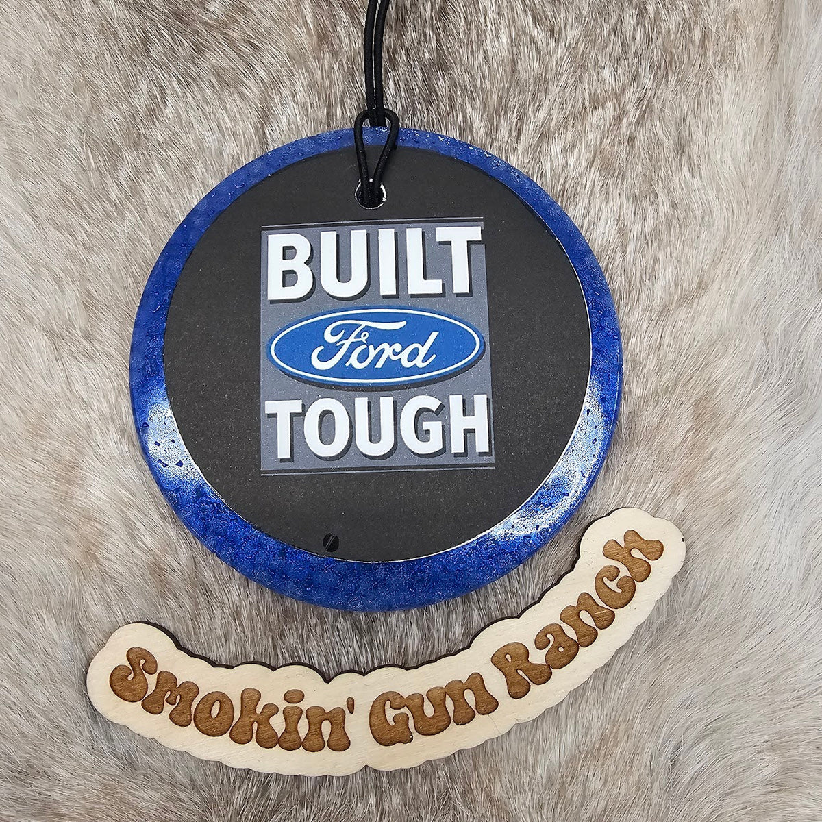 Blue round cardstock freshie reading Built Ford Tough