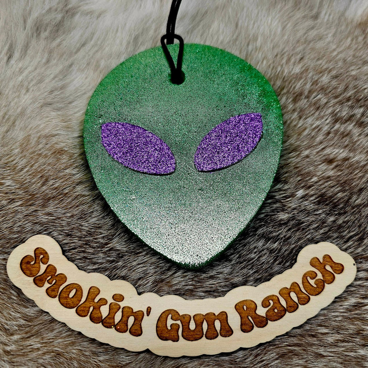 Gray alien head freshie with purple eyes