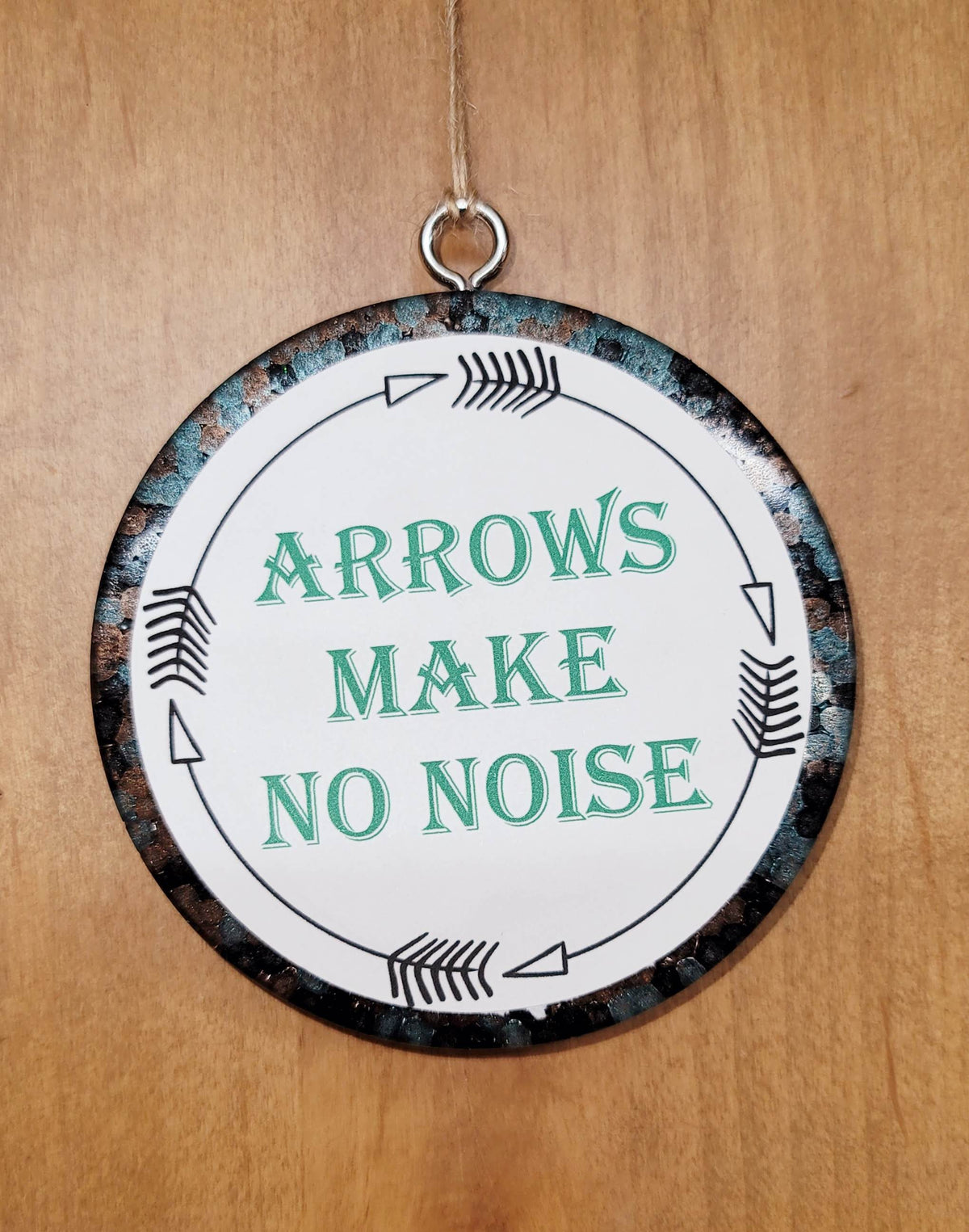 Silver round cardstock freshie reading Arrows Make No Noise