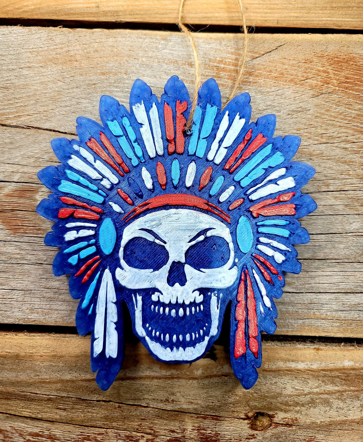 Blue and orange skull headdress freshie on wood