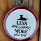 Pink round cardstock freshie reading Less People More Dogs