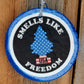 Blue round cardstock freshie reading Smells Like Freedom