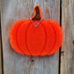 Orange pumpkin freshie hanging on wood