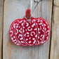 Red and white leopard print pumpkin freshie hanging on wood