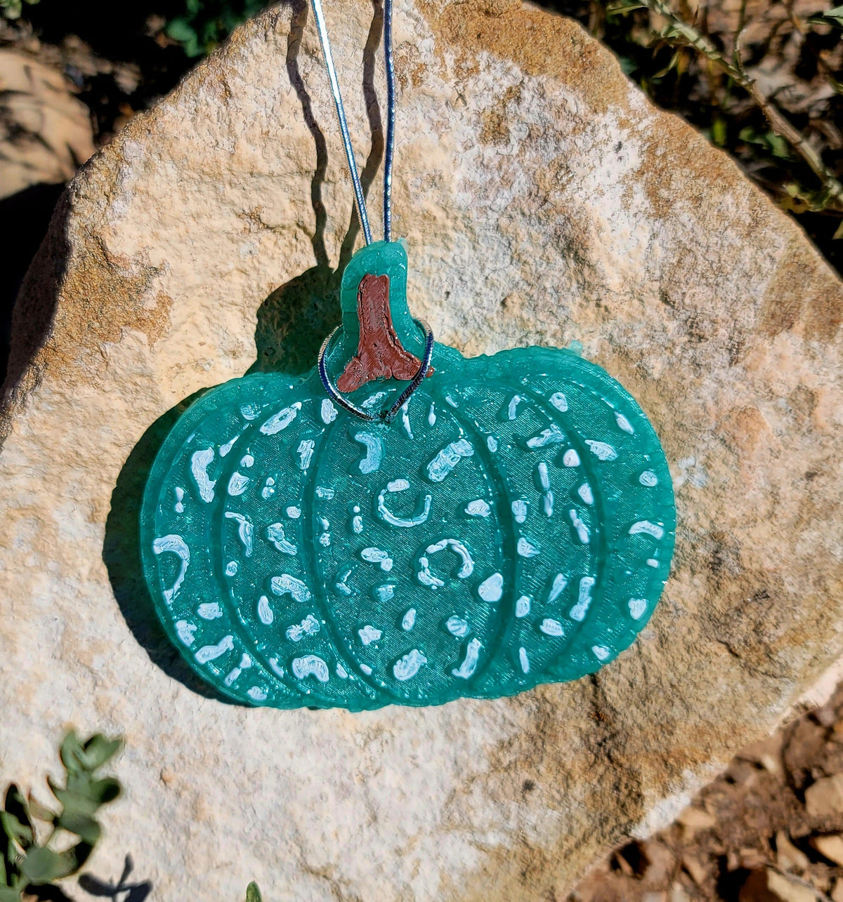 Teal leopard print pumpkin freshie hanging outdoors
