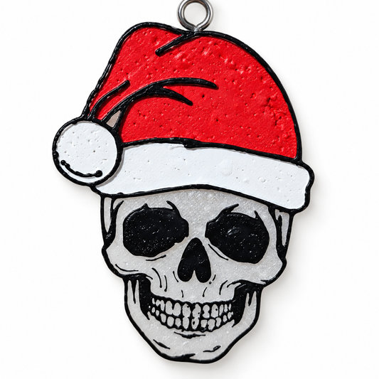 White skull freshie wearing a red Santa hat on white background
