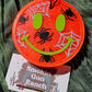 Orange spider smiley Halloween car freshie with lime green face and silver webs